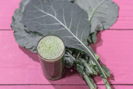 Green juice. Detox drink. Slimming drink. Cabbage leaves (Brassica sylvestris L.). Vegetables on...