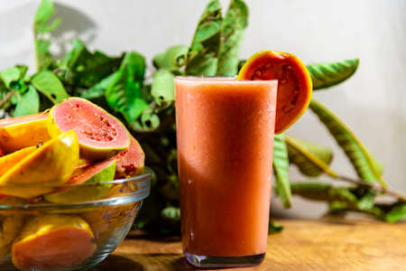 Guava juice and fruits (Psidium guajava). Guava is the fruit of guava. The guava has a tortuous trunk, with a smooth bark, which, when it grows old, comes off in thin brown blades.の写真素材