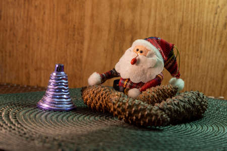 Santa Claus amid pine cones and Christmas motifsの写真素材