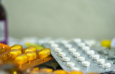 Bottles and pills. A tablet is the solid form of a medicated powder, prepared by compression, with or without added binders. Slots may be provided to allow dose sharingの写真素材