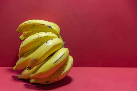 Bunch of pink grape and glass of natural juice. Wood background. Table grapes ready for consumption. Crystal with grape juice. Fruit for making juices and jams. Vine product. Detox berries.の写真素材