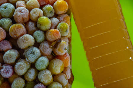 Bottle of acerola juice anchored in a tower of frozen acerola fruits. Detox drink and rich in vitamin c. Exotic fruit. Natural energetic. Natural and anti-flu juice.の写真素材