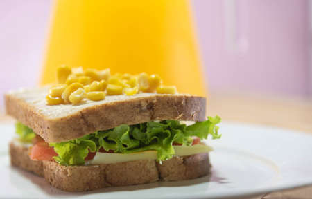 Homemade sandwich made with corn, salad, tomatoes and cheese. Fast feeding. Fast food food. Brazilian cuisine.の写真素材