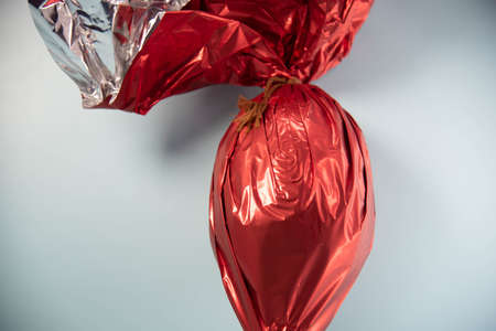 Chocolate egg packed for gift on Easter day. Christian holiday. Candy and mischief. Easter egg. Gift for children and adults. Bunny gifts in the Christian tradition.の写真素材