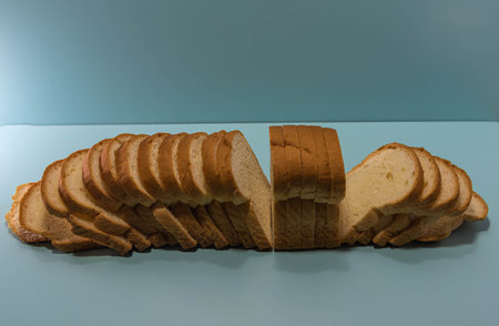 Industrial bread on blue background. Loaf bread. Loaf of bread is a product obtained from cooking...