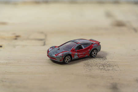 Old toy car on the wooden background. Toy miniatures. Retro car. Child's play. Collection item....