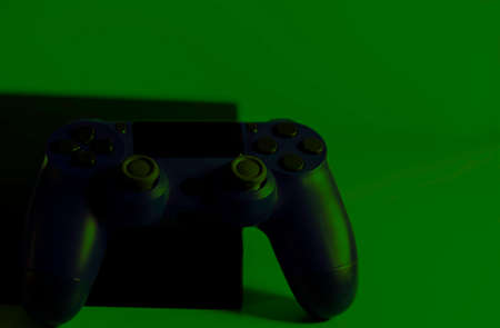 Controls and video game console on light background. Electronic game accessories. Video game gaming platform. Wish item for gamers. Modern, wireless game and directional control.の写真素材