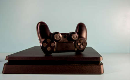 Controls and video game console on light background. Electronic game accessories. Video game gaming...