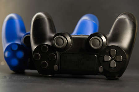 Video game controls on the dark background. Electronic game accessories. State-of-the-art...