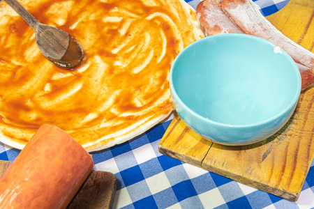 Ingredients and utensils for preparing homemade pizza. Pizza with tomato sauce. Italian cuisine. Amateur cuisine. Food. Typical food preparation.の写真素材