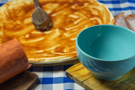 Ingredients and utensils for preparing homemade pizza. Pizza with tomato sauce. Italian cuisine. Amateur cuisine. Food. Typical food preparation.の写真素材
