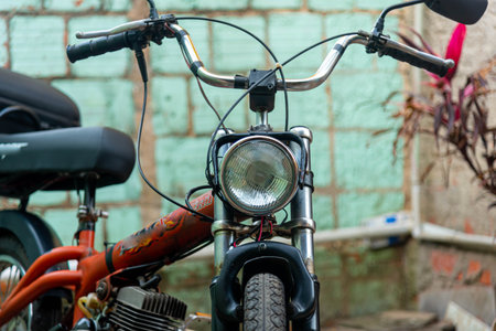 Motor bike or scooter parked in residential yard. transport vehicle. Alternative transport. Old motorbike. Machine. Scooter.の写真素材