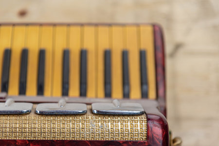 Old accordion on a wooden background. Close-up, selective focus.の写真素材