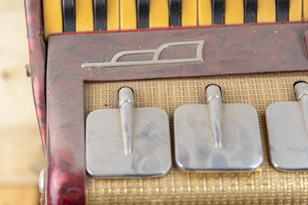 old accordion on a wooden background, close-up, selective focus