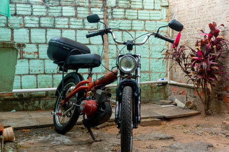 Motor bike or scooter parked in residential yard. transport vehicle. Alternative transport. Old motorbike. Machine. Scooter.の写真素材