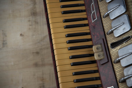 Old red accordion. Wind musical instrument. Old concertina. Musical orchestra instrument. Equipment that reproduces musical sounds.の写真素材