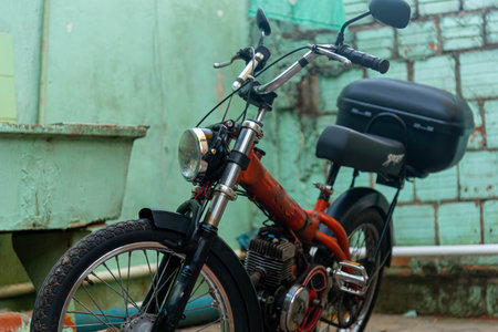 Motor bike or scooter parked in residential yard. transport vehicle. Alternative transport. Old motorbike. Machine. Scooter.の写真素材