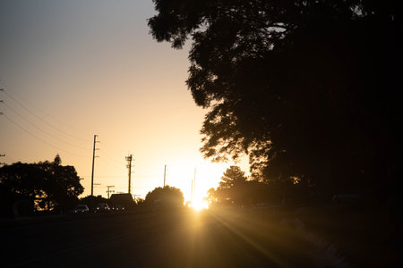 Sunset silhouette in rural landscape. Dramatic sky at dusk. Nature. Feelings of peace and calm.の写真素材