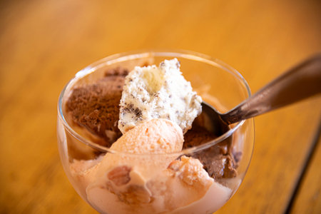 Ice cream in a bowl on a wooden table.の写真素材