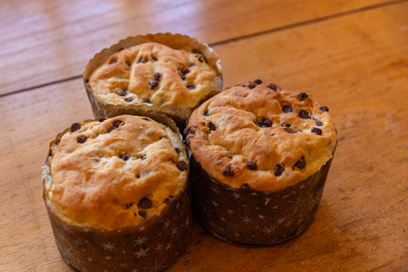 Chocolate chip muffins with raisins on a wooden table