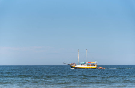 Tourist boat on the coast of Gamboa beach, Santa Catarina, Brazil.NEF.