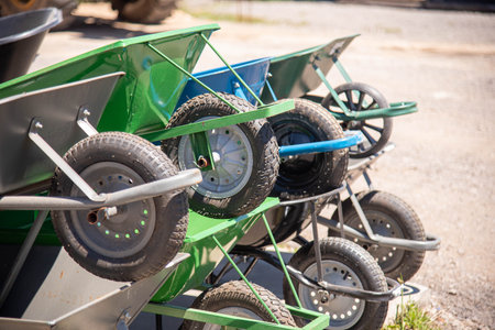 Wheelbarrows displayed for sale in an outdoor setting..