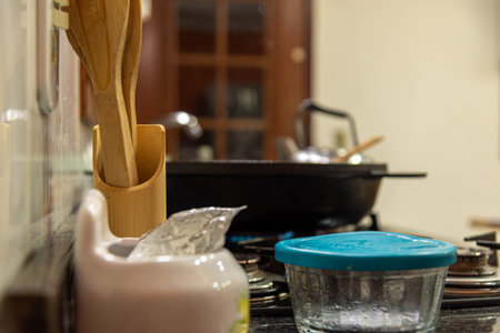 Utensils in a residential kitchen on a gas stove..