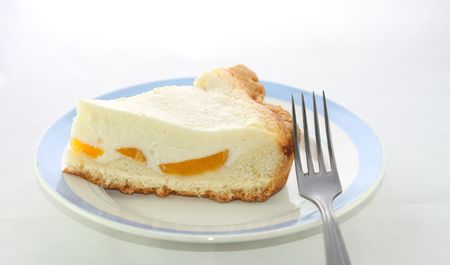 Cheesecake with apricots on a white backgroundの写真素材