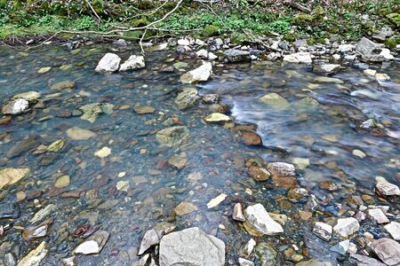 Stones in the clear water of a mountain river.