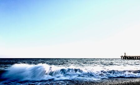 sea coast with light waves in the eveningの写真素材
