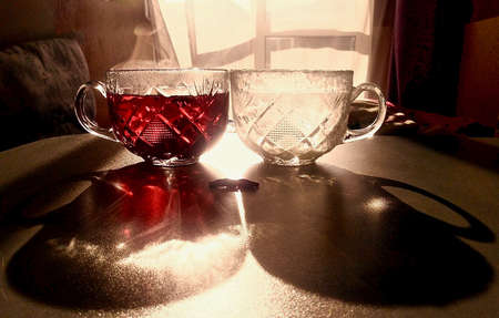 cups with hot and cold drinks with shadows