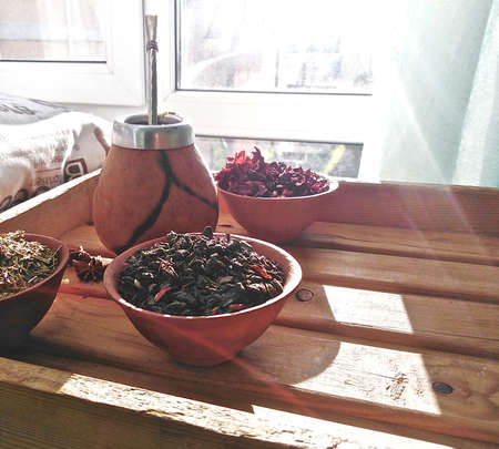 unbrewed tea and calabash on a wooden tray by the window