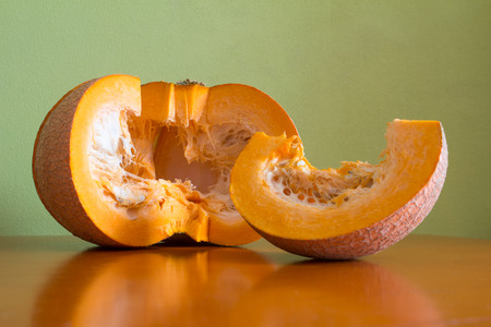 Cooking pumpkin porridge on the kitchen table green wallの写真素材