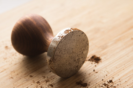 coffee tamper for coffee on a wooden boardの写真素材