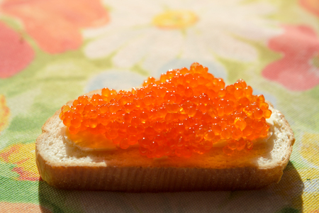red caviar on a white bread on a tableの写真素材