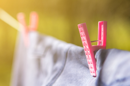 clothespin on clothesline keeps clothes on. copy space background