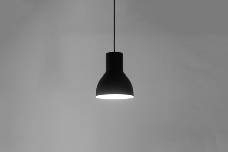 lamp on the wire on the wall isolated grayy background