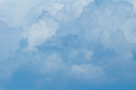 Blue sky background with cloudsの写真素材