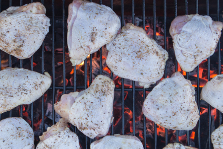 raw chicken on a charcoal grill closeupの写真素材