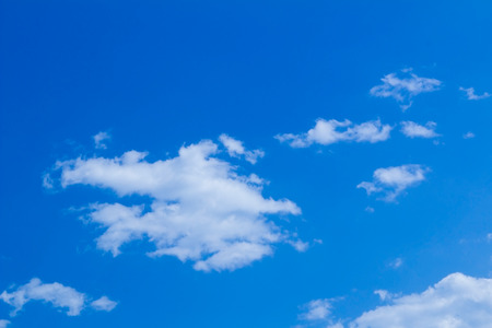 Blue sky background with light white cloudsの写真素材