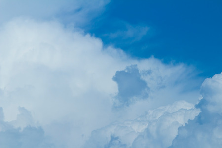 Blue sky background with light white cloudsの写真素材