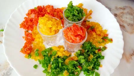 Homemade tutti fruity Lots of slices of dry papaya candy on plate on white background