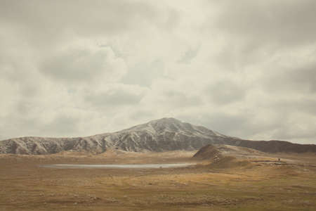 Mount Aso and Kusasenri in winter. covered by golden yellow grassland - Kumamoto, Japanの写真素材