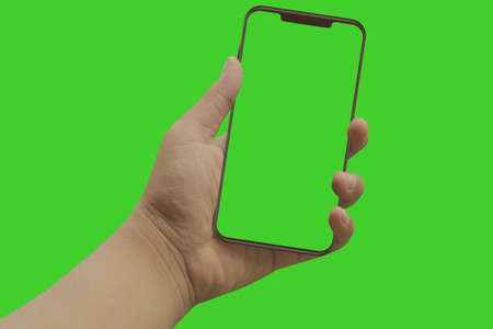 Modern smart phone in hand. Green screen and backgroundの写真素材
