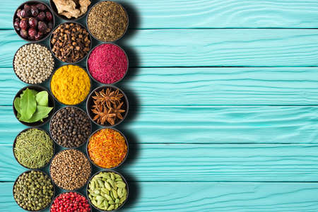 Seasonings on a wooden table. A collection of spices with a place for mealsの写真素材