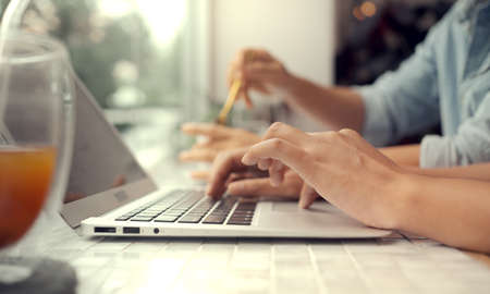 Young businesswoman and businessman working together usingの写真素材