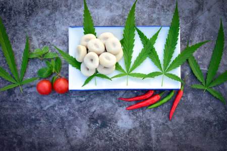 Steamed meatballs, hemp leaves and vegetables on dark backgroundの写真素材