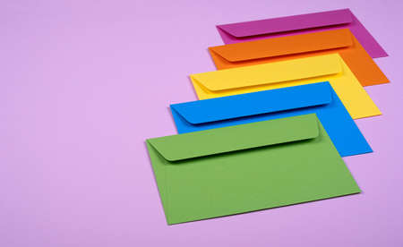 tidy coloured envelopes on a light pink background