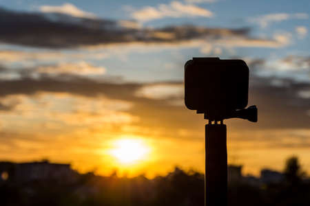 Silhouette abstract Action camera in front of the twilight dawn sky, Technology and Nature conceptの写真素材