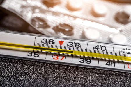 temperature 38 degrees Celsius on a medical thermometer macrophotoの写真素材